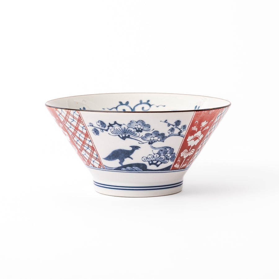 A blue red and white ceramic Japanese ramen bowl featuring a cute dinosaur silhouette amidst traditional pine and floral patterns