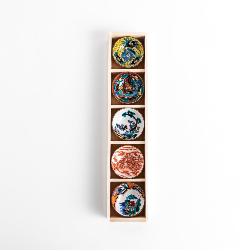 Elegant set of five sake cups with intricate floral and traditional patterns, presented in a wooden box, showcasing timeless Japanese craftsmanship and design.