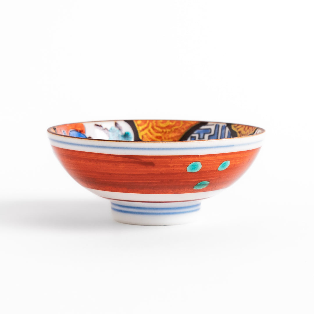Traditional sake cup featuring a detailed design of a scenic mountain landscape, with vibrant colors and intricate patterns in blue, green, and orange.
