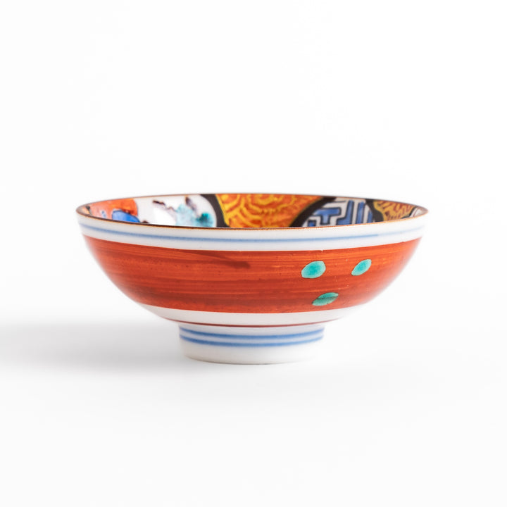 Traditional sake cup featuring a detailed design of a scenic mountain landscape, with vibrant colors and intricate patterns in blue, green, and orange.