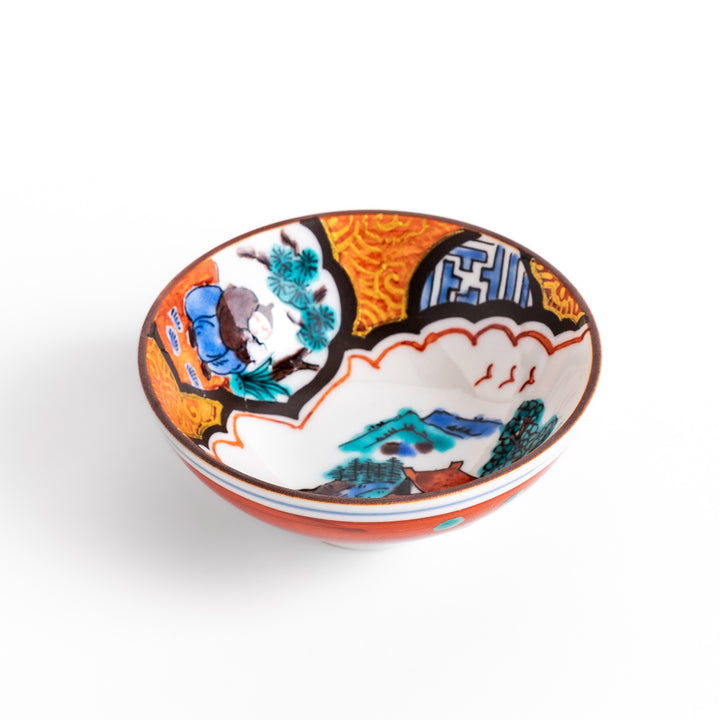 Traditional sake cup featuring a detailed design of a scenic mountain landscape, with vibrant colors and intricate patterns in blue, green, and orange.