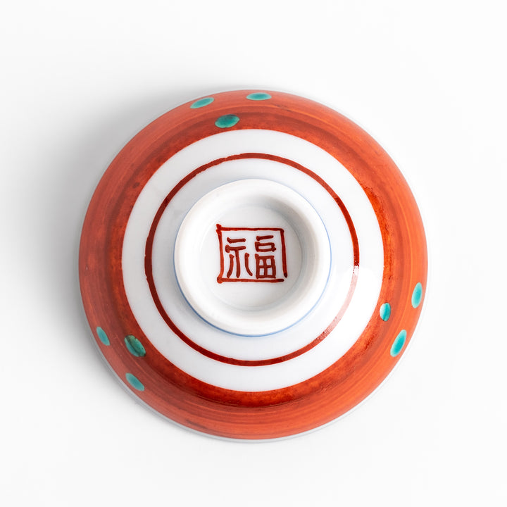 Traditional sake cup featuring a detailed design of a scenic mountain landscape, with vibrant colors and intricate patterns in blue, green, and orange.
