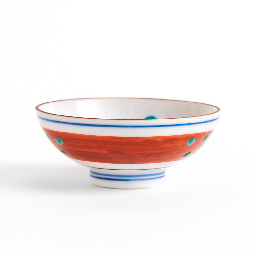 Traditional sake cup showcasing a hand-painted scene of a bird perched on a tree, surrounded by lush greenery, highlighting vibrant colors and Japanese artistry.
