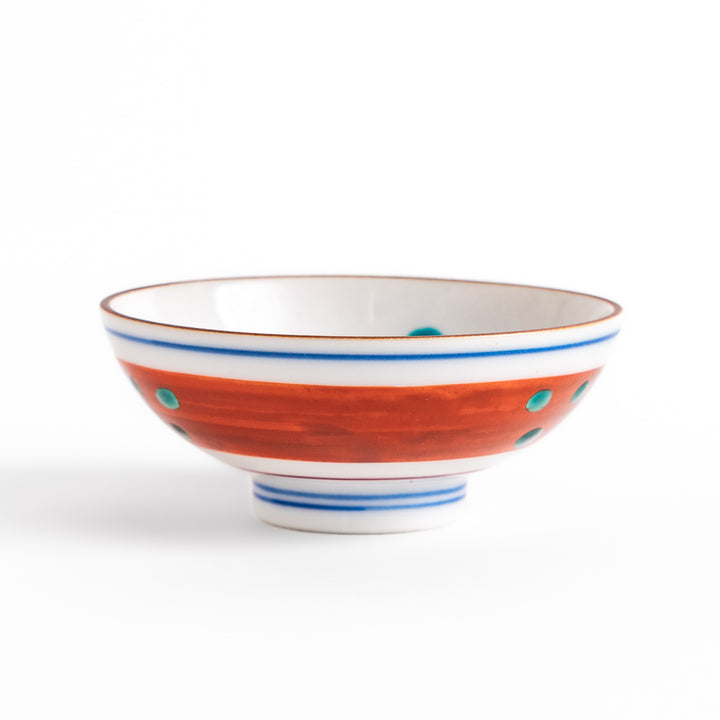 Traditional sake cup showcasing a hand-painted scene of a bird perched on a tree, surrounded by lush greenery, highlighting vibrant colors and Japanese artistry.