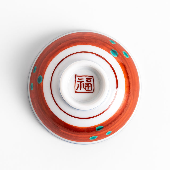 Traditional sake cup showcasing a hand-painted scene of a bird perched on a tree, surrounded by lush greenery, highlighting vibrant colors and Japanese artistry.