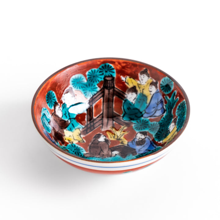 Sake cup with a vivid depiction of a historical scene, featuring figures gathered around a fire, set against a colorful, intricate background.