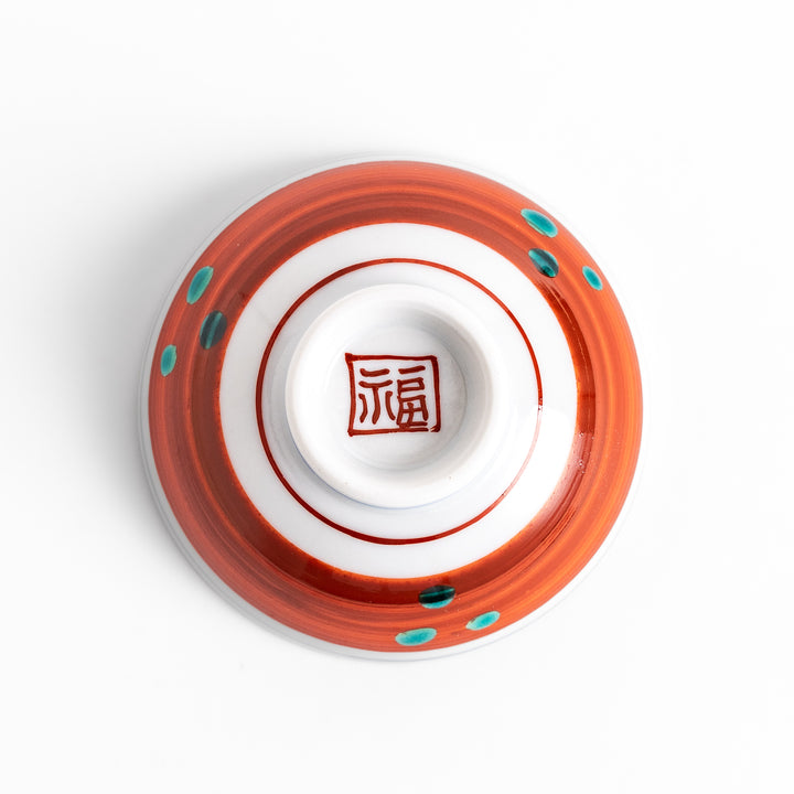 Sake cup with a vivid depiction of a historical scene, featuring figures gathered around a fire, set against a colorful, intricate background.