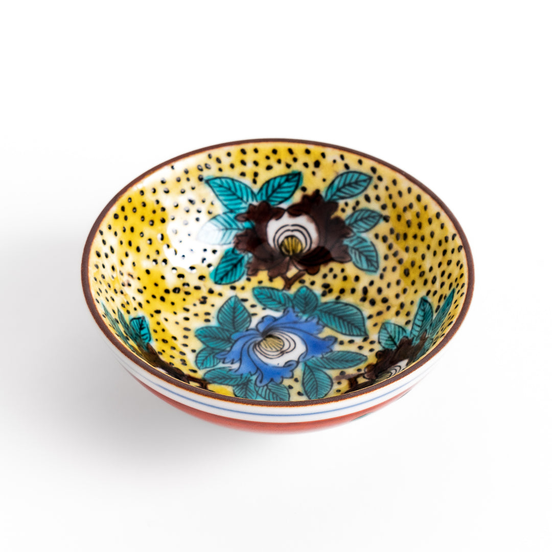 Sake cup featuring a bright yellow background with bold blue and brown flowers, creating a striking and vibrant floral pattern in traditional Japanese style