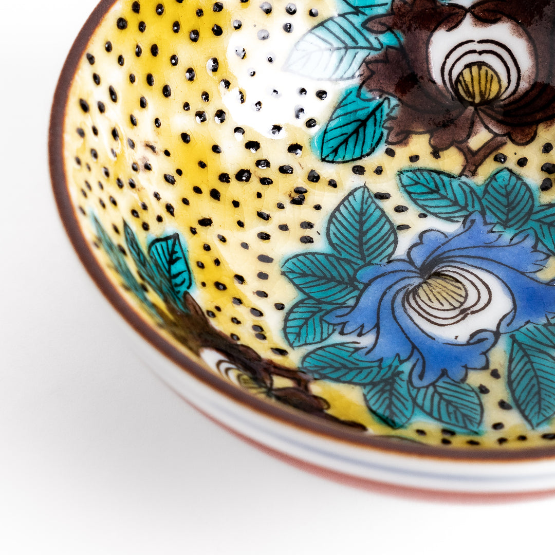 Sake cup featuring a bright yellow background with bold blue and brown flowers, creating a striking and vibrant floral pattern in traditional Japanese style