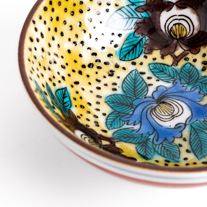 Sake cup featuring a bright yellow background with bold blue and brown flowers, creating a striking and vibrant floral pattern in traditional Japanese style