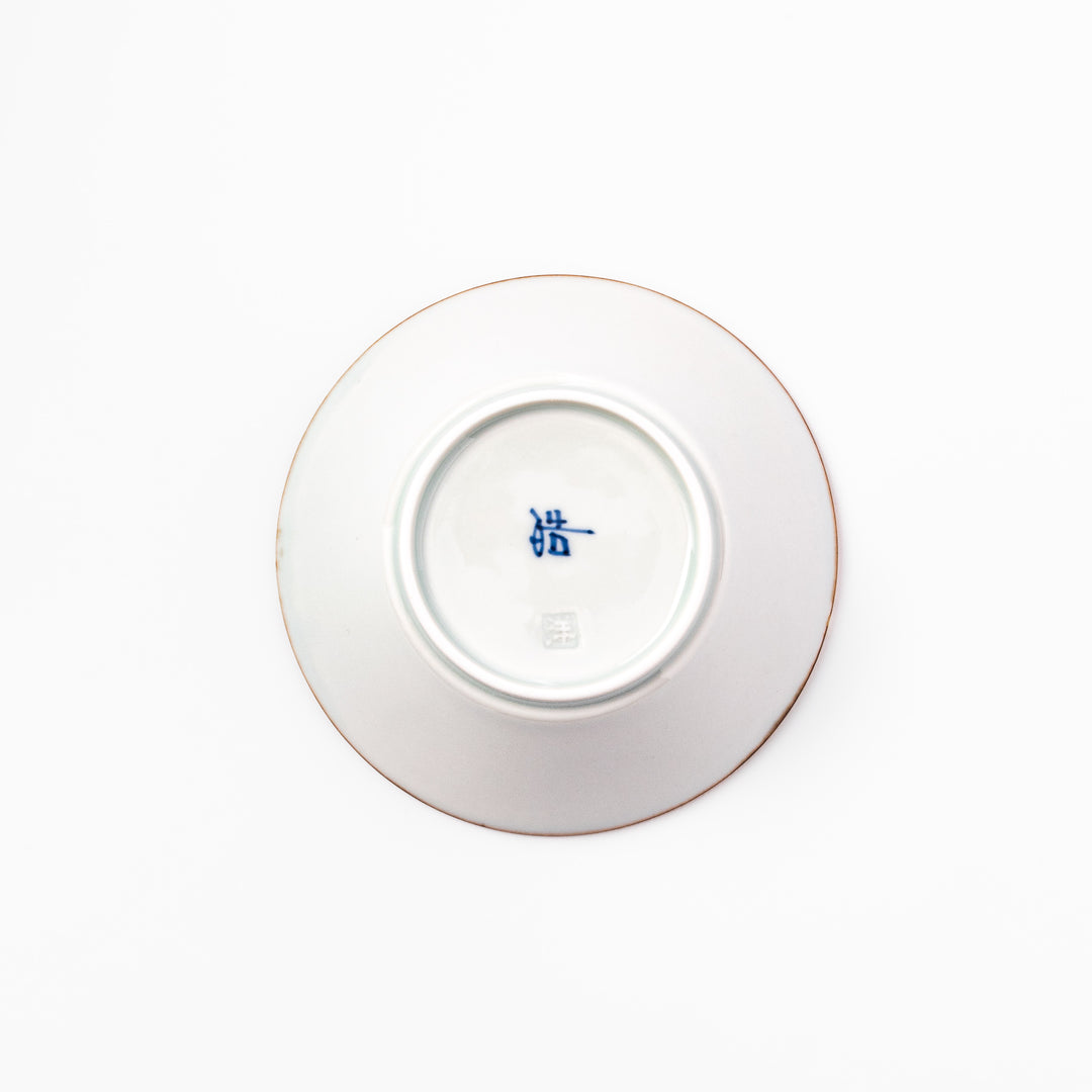 White dessert bowl with vertical ridges, blue floral accents around the rim, and a warm brown edge, perfect for sweets or fruit.