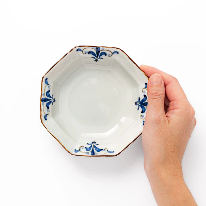 Arita porcelain octagonal cereal bowl with blue floral leaf pattern and gold rim, ideal for rice or soup.