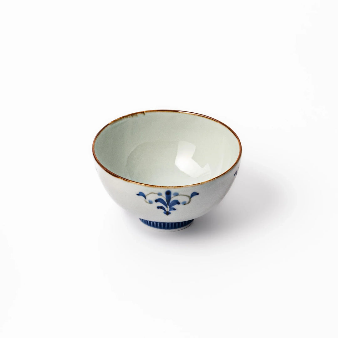 Arita porcelain rice bowl with blue floral leaf motif and gold rim, perfect for serving rice or soup.