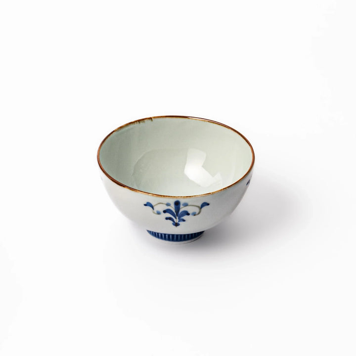 Arita porcelain rice bowl with blue floral leaf motif and gold rim, perfect for serving rice or soup.