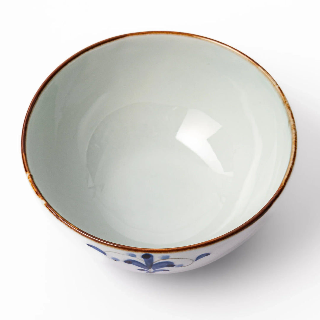 Arita porcelain rice bowl with blue floral leaf motif and gold rim, perfect for serving rice or soup.