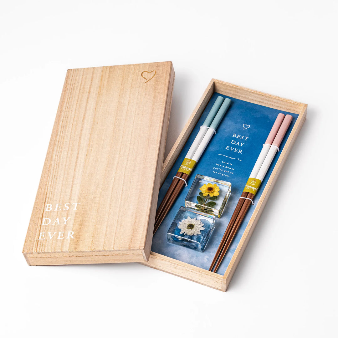 Floral-themed Japanese chopsticks gift set with pastel handles and clear rests featuring pressed sunflower and daisy.