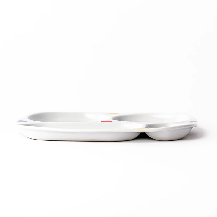 White ceramic kids plate with four divided sections, decorated with pink, yellow, red, and purple flower motifs