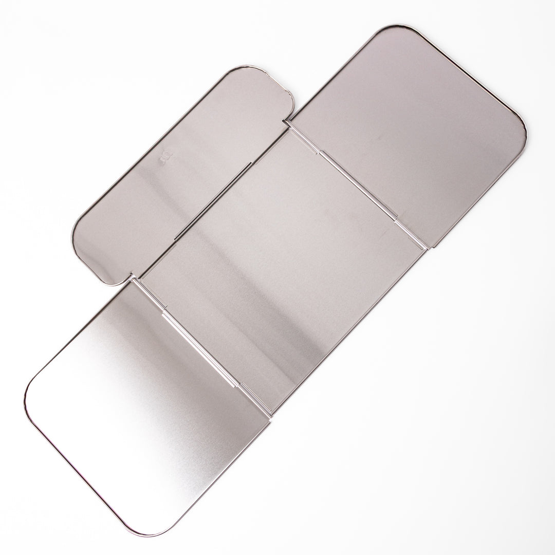 Japanese Foldable Stainless Steel Stove Splatter Guard fully assembled and standing on a white background