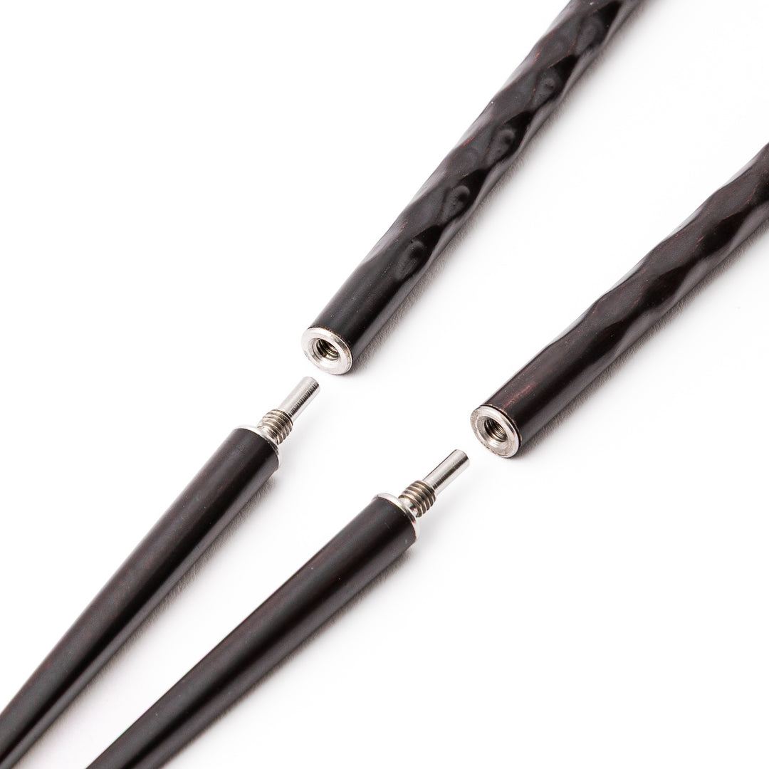 Dark wood Japanese travel chopsticks unscrewed into two parts to highlight the portable design and sturdy metal joints