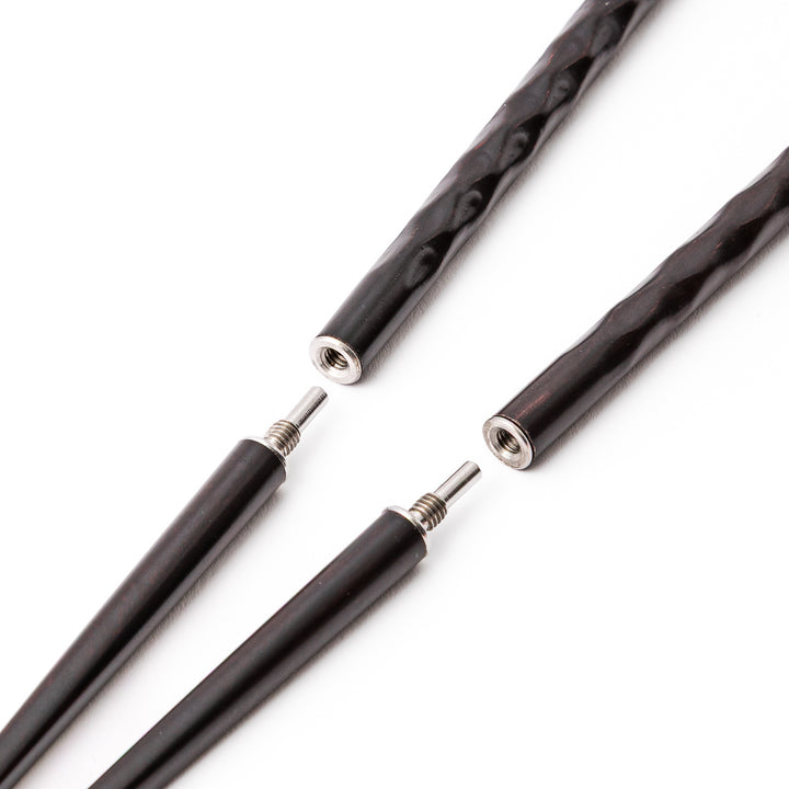 Dark wood Japanese travel chopsticks unscrewed into two parts to highlight the portable design and sturdy metal joints