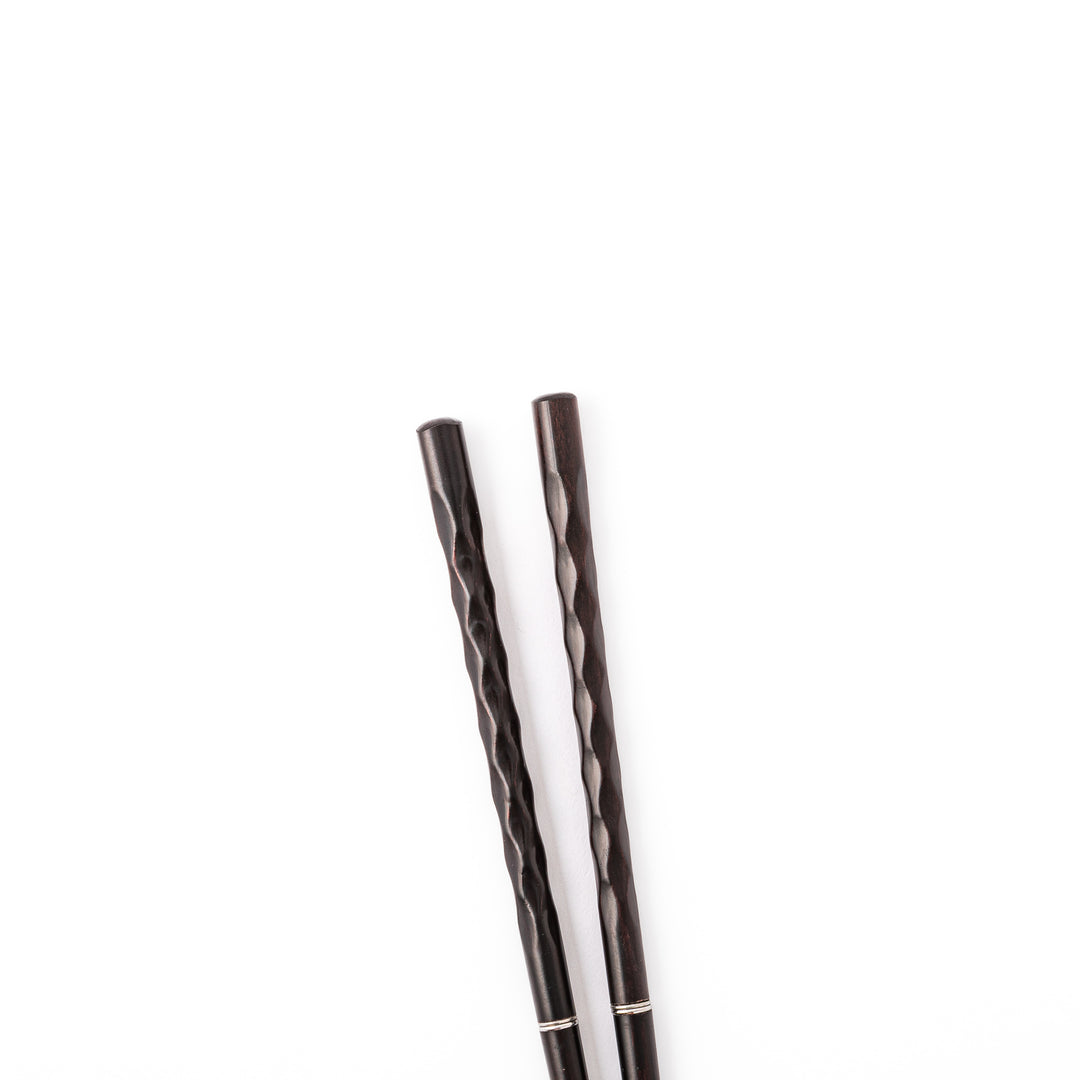 Gentle Wave portable Japanese travel chopsticks carved from dark natural wood showing a textured wavy design
