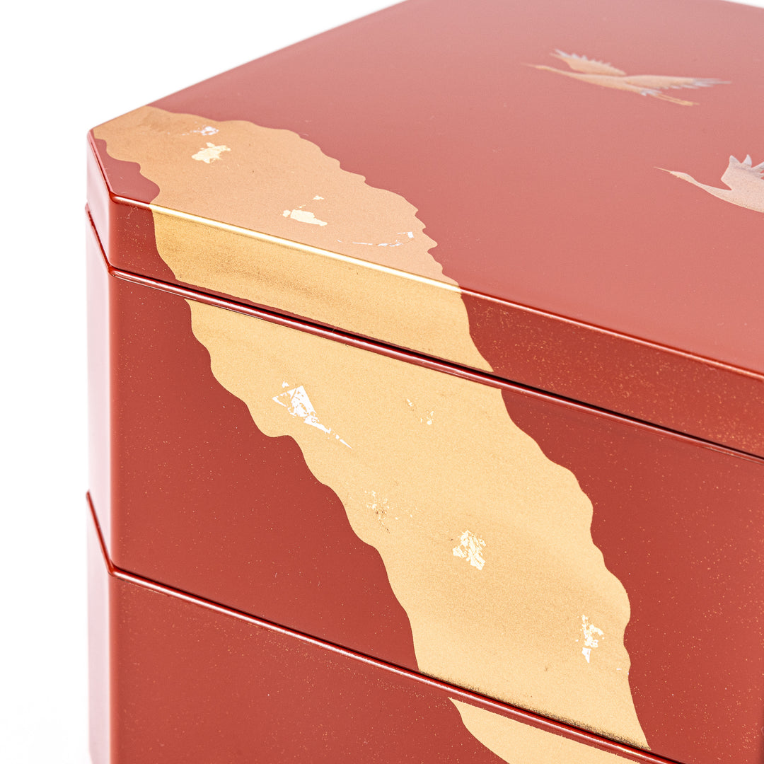 Gold River & Crane Japanese Jubako Box in hexagonal form with gold river and crane motif on vermilion red lacquer, perfect for festive food presentation.