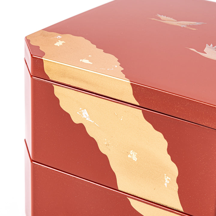 Gold River & Crane Japanese Jubako Box in hexagonal form with gold river and crane motif on vermilion red lacquer, perfect for festive food presentation.