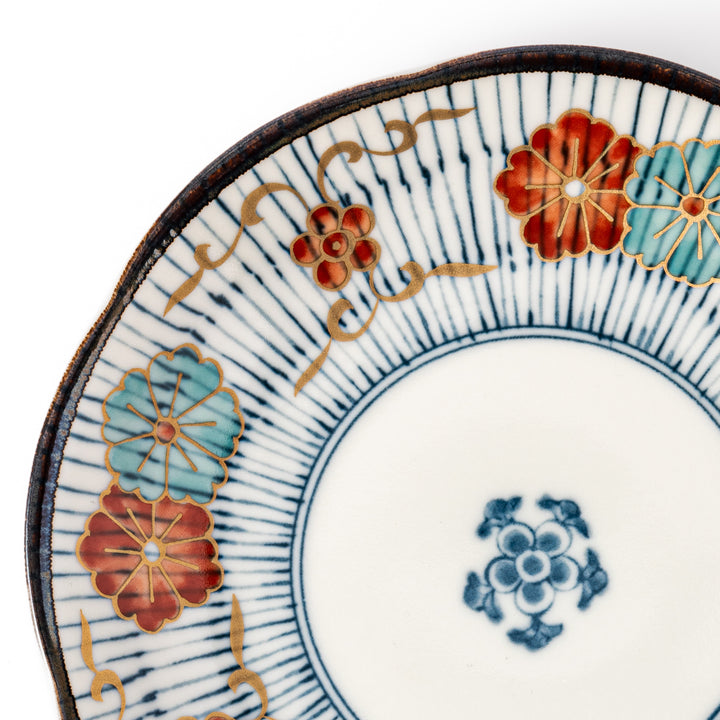 Scalloped Japanese dessert plate with vertical blue stripes and red, teal, and gold floral accents, perfect for serving sweets or small treats in style.