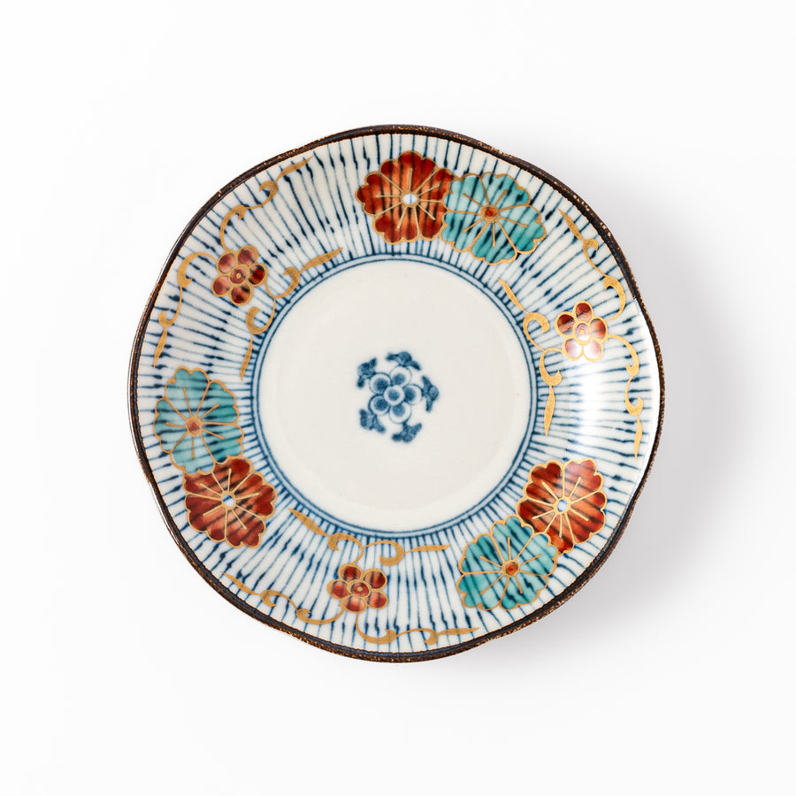 Scalloped edge Japanese sauce dish with vertical blue stripes and red, teal, and gold floral motifs, ideal for serving condiments with elegance.