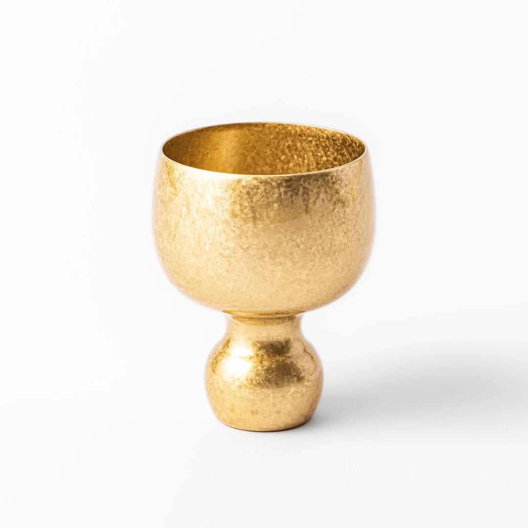 Golden Japanese brass sake cup with rounded base and hammered texture for refined traditional drinking.