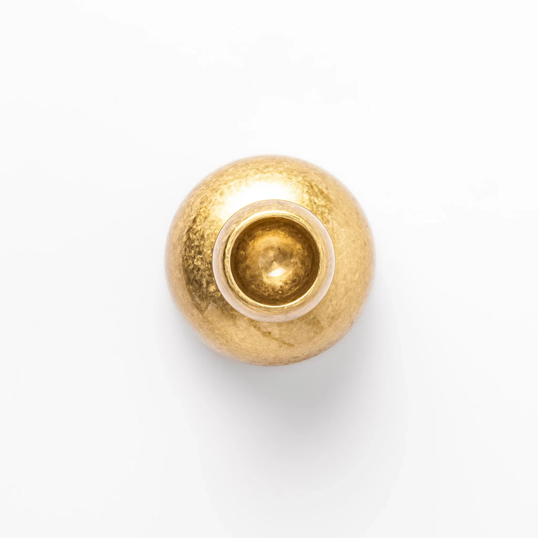 Golden Japanese brass sake cup with rounded base and hammered texture for refined traditional drinking.