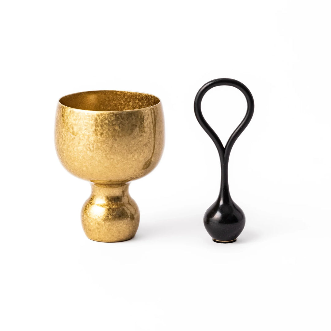 Golden Japanese brass sake cup with rounded base and hammered texture for refined traditional drinking.