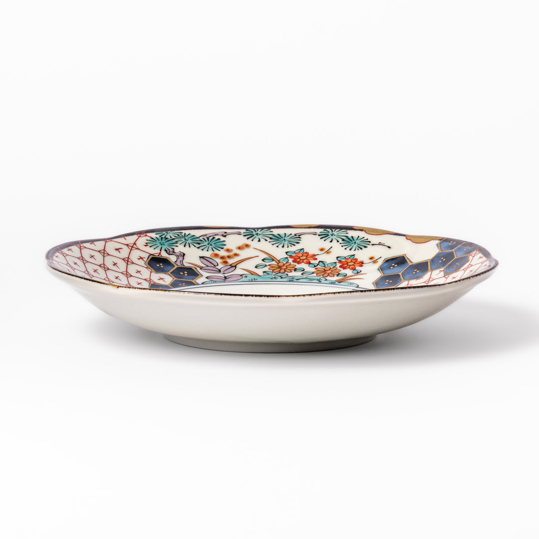 Scalloped Japanese dessert plate with red lattice, navy hexagons, and multicolor floral design, perfect for adding charm to elegant table settings.