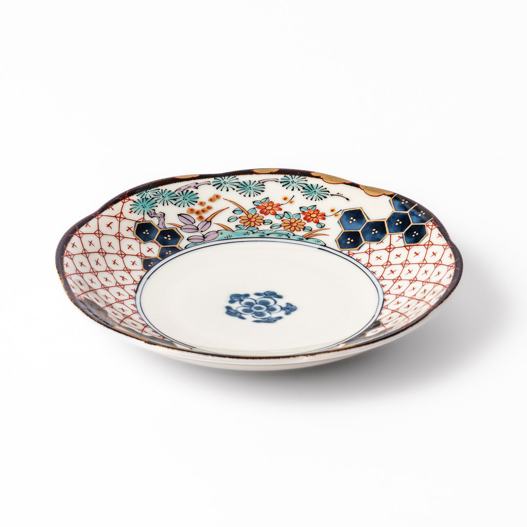 Scalloped Japanese dessert plate with red lattice, navy hexagons, and multicolor floral design, perfect for adding charm to elegant table settings.