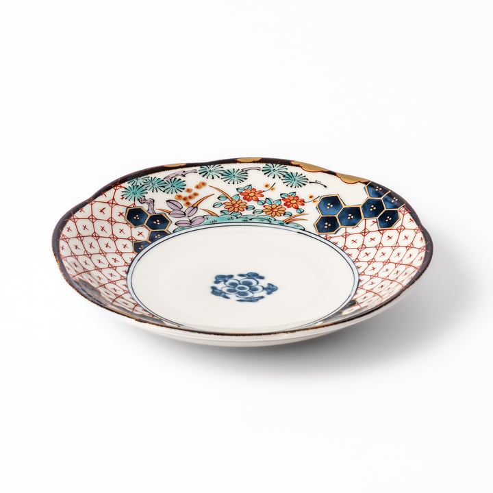 Scalloped Japanese dessert plate with red lattice, navy hexagons, and multicolor floral design, perfect for adding charm to elegant table settings.