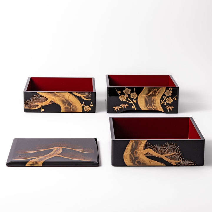 Golden Pine Three-Tier Japanese Jubako Box featuring a hand-painted pine tree design in gold on black lacquer, perfect for festive meals and special occasions.
