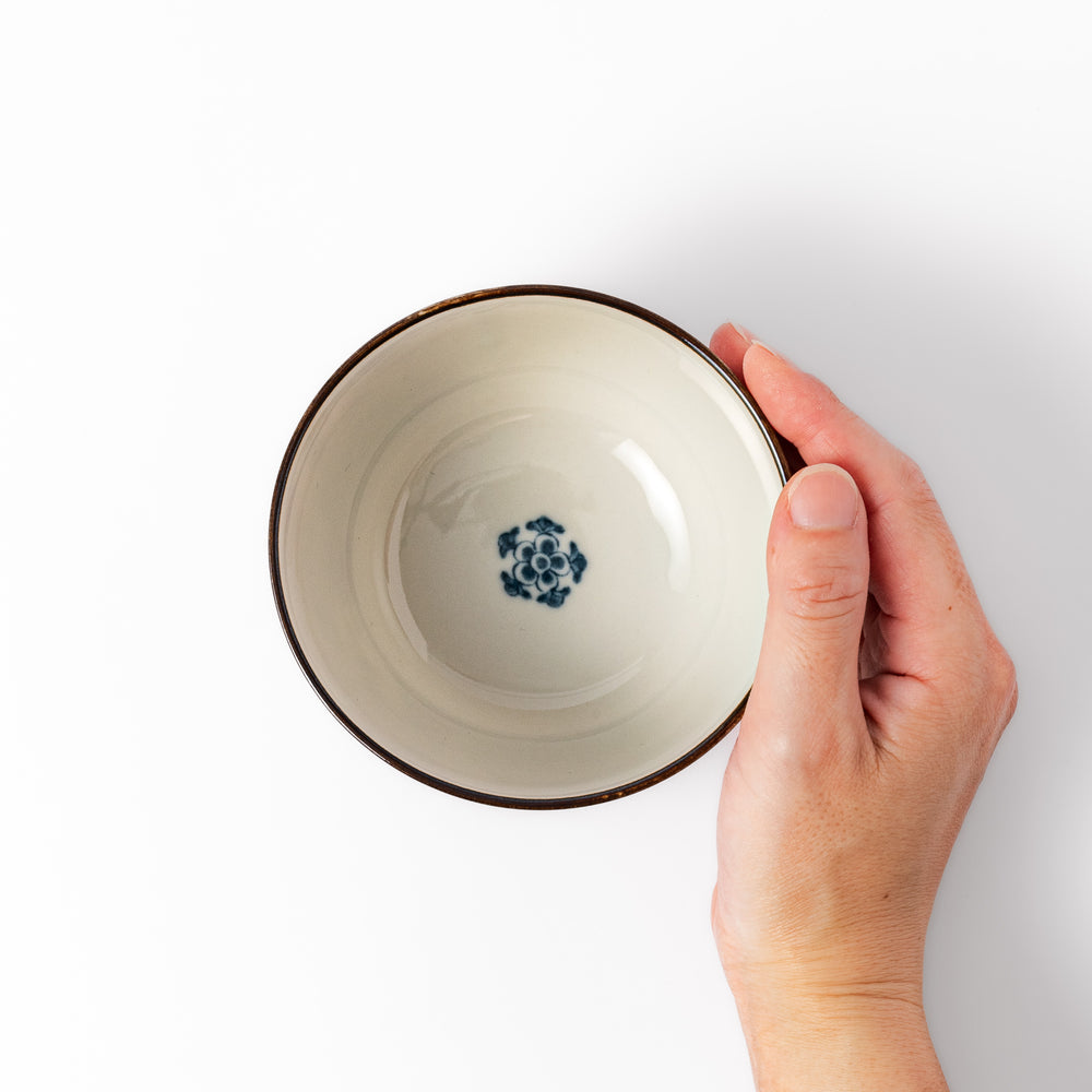 Traditional Japanese rice bowl featuring red, green, and gold motifs with waves, florals, and flying birds—perfect for refined, elegant dining.