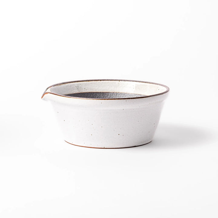 White ceramic suribachi mortar bowl with a smooth dark interior and spout, designed for effortless grinding and elegant table presentation.