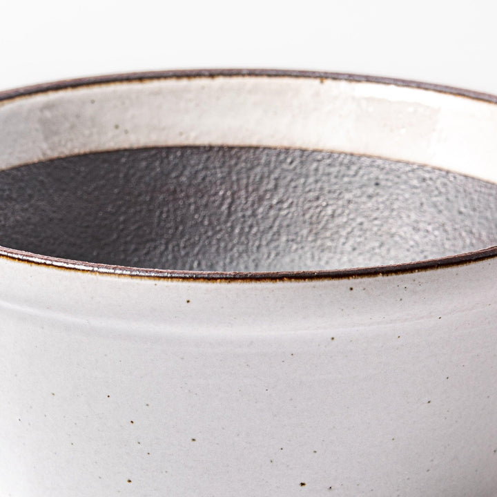 White ceramic suribachi mortar bowl with a smooth dark interior and spout, designed for effortless grinding and elegant table presentation.