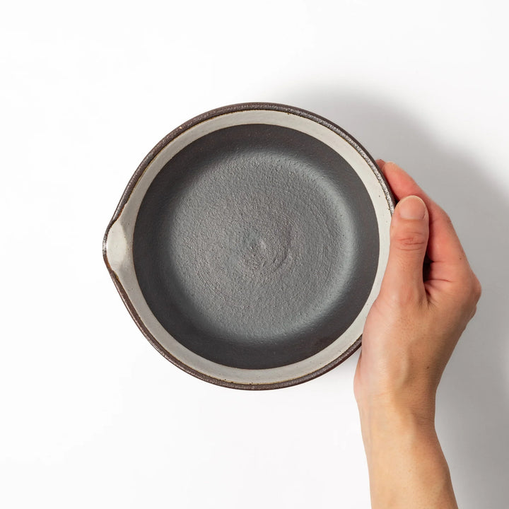 White ceramic suribachi mortar bowl with a smooth dark interior and spout, designed for effortless grinding and elegant table presentation.