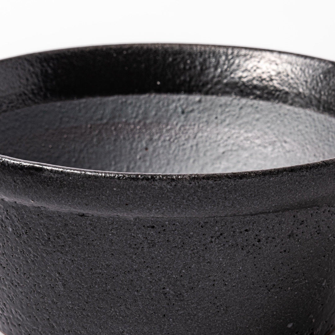 Black ceramic suribachi mortar bowl with a smooth interior and spout, perfect for grinding or mixing without grooves for easy cleanup.