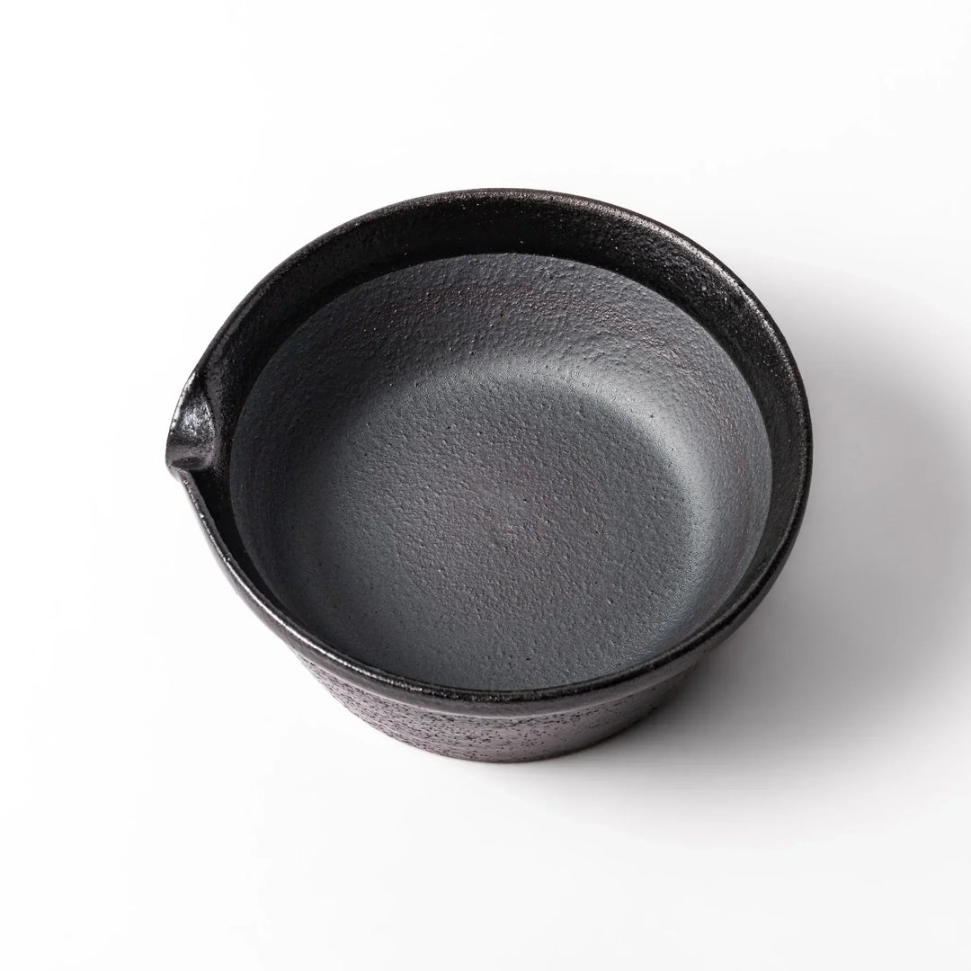 Black ceramic suribachi mortar bowl with a smooth interior and spout, perfect for grinding or mixing without grooves for easy cleanup.