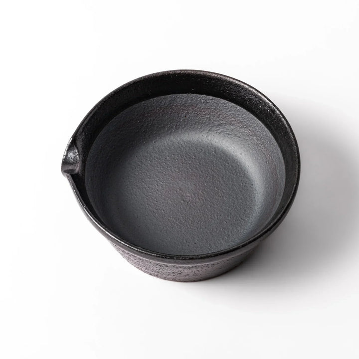Black ceramic suribachi mortar bowl with a smooth interior and spout, perfect for grinding or mixing without grooves for easy cleanup.