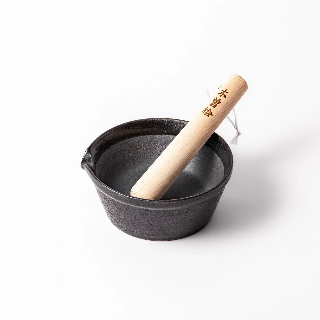 Black ceramic suribachi mortar bowl with a smooth interior and spout, perfect for grinding or mixing without grooves for easy cleanup.