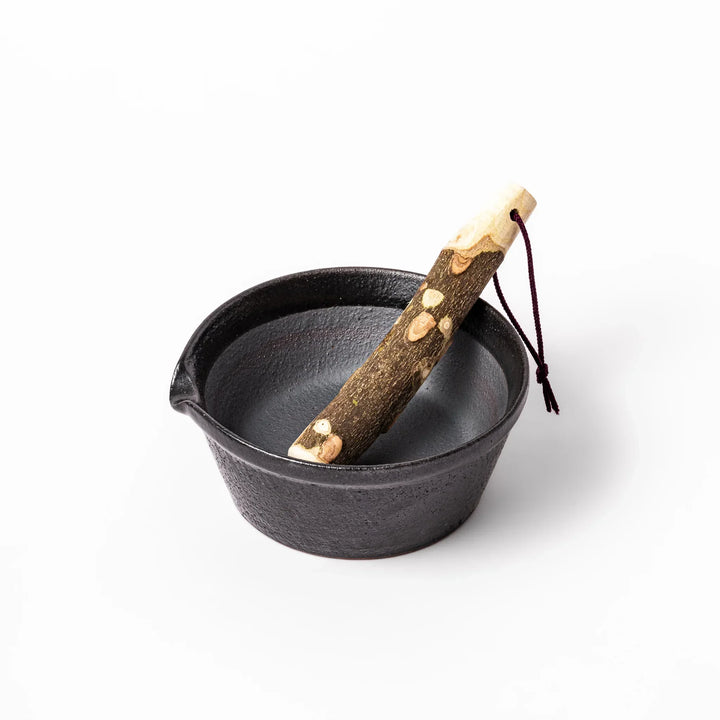 Black ceramic suribachi mortar bowl with a smooth interior and spout, perfect for grinding or mixing without grooves for easy cleanup.