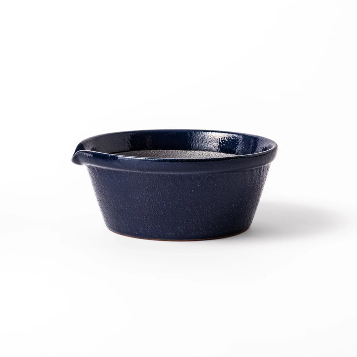 Deep blue ceramic suribachi mortar bowl with a smooth interior and spout, ideal for grinding and serving sauces or dressings with ease.