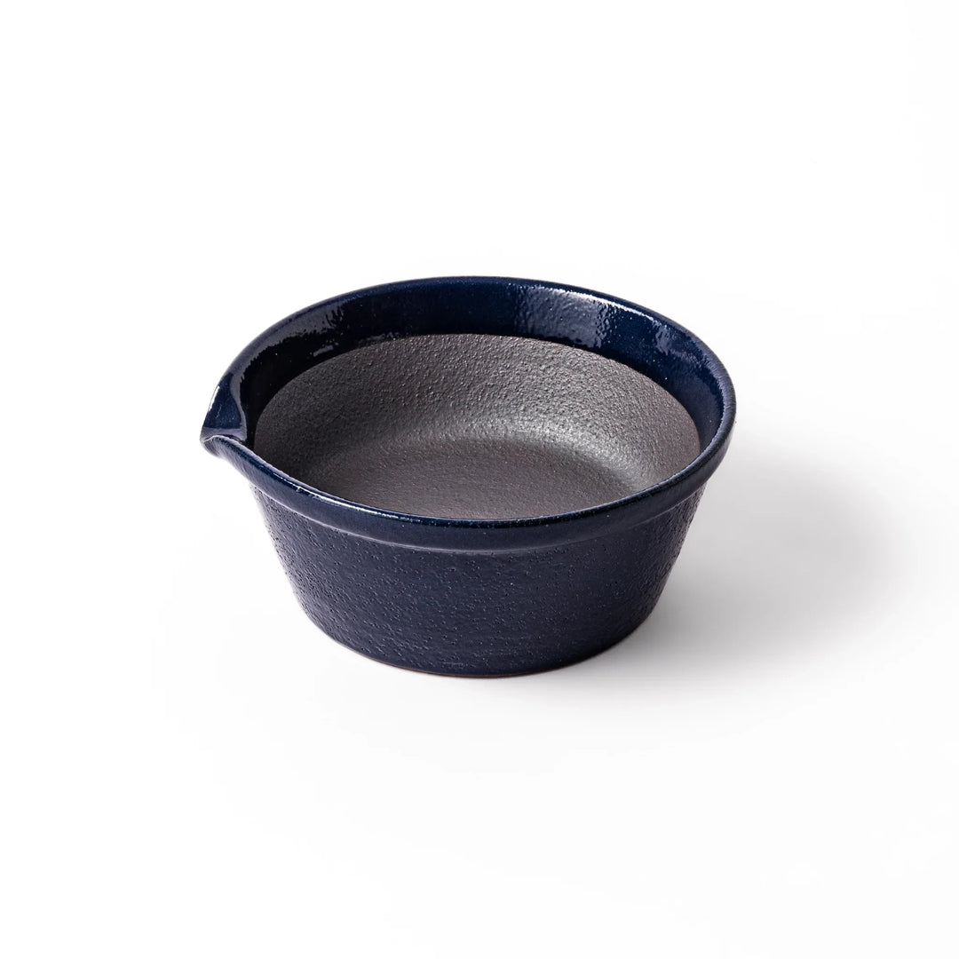 Deep blue ceramic suribachi mortar bowl with a smooth interior and spout, ideal for grinding and serving sauces or dressings with ease.