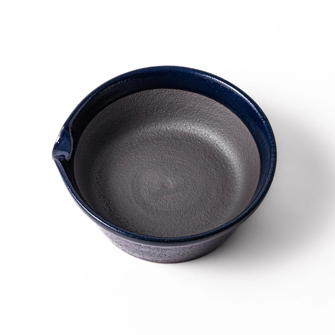 Deep blue ceramic suribachi mortar bowl with a smooth interior and spout, ideal for grinding and serving sauces or dressings with ease.