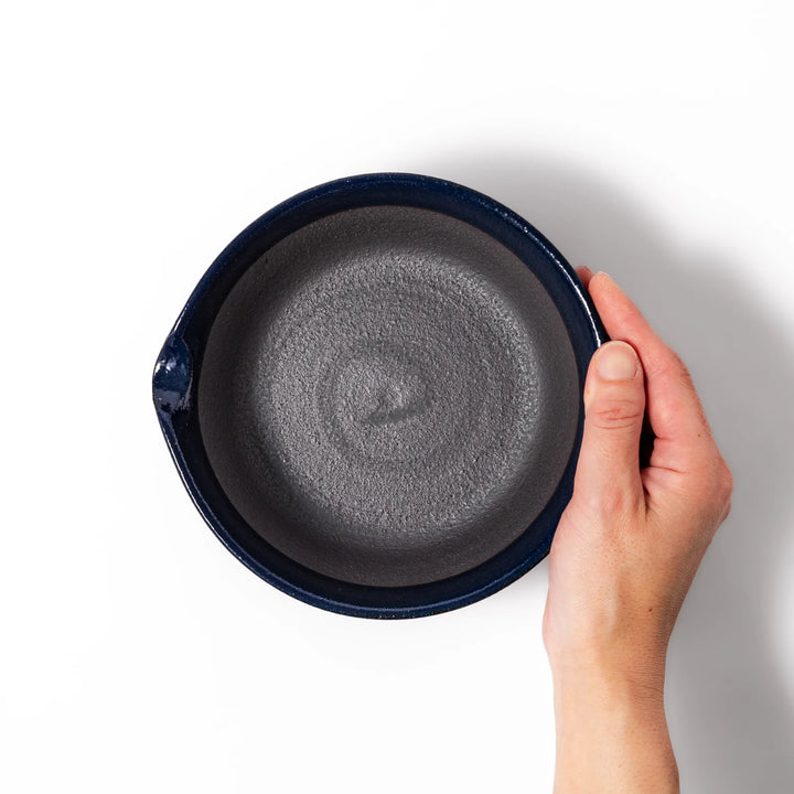 Deep blue ceramic suribachi mortar bowl with a smooth interior and spout, ideal for grinding and serving sauces or dressings with ease.