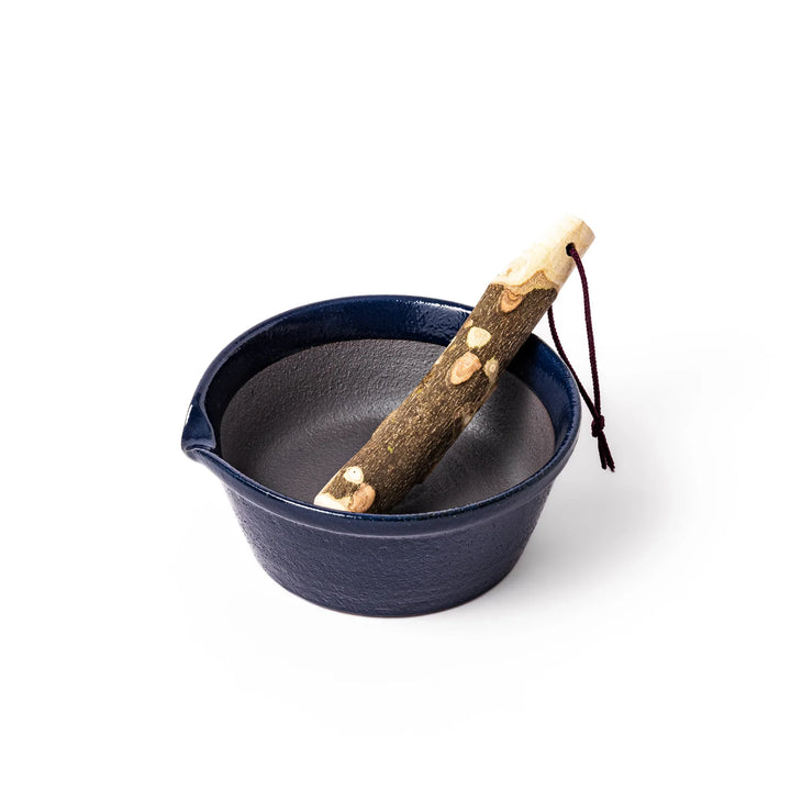 Deep blue ceramic suribachi mortar bowl with a smooth interior and spout, ideal for grinding and serving sauces or dressings with ease.